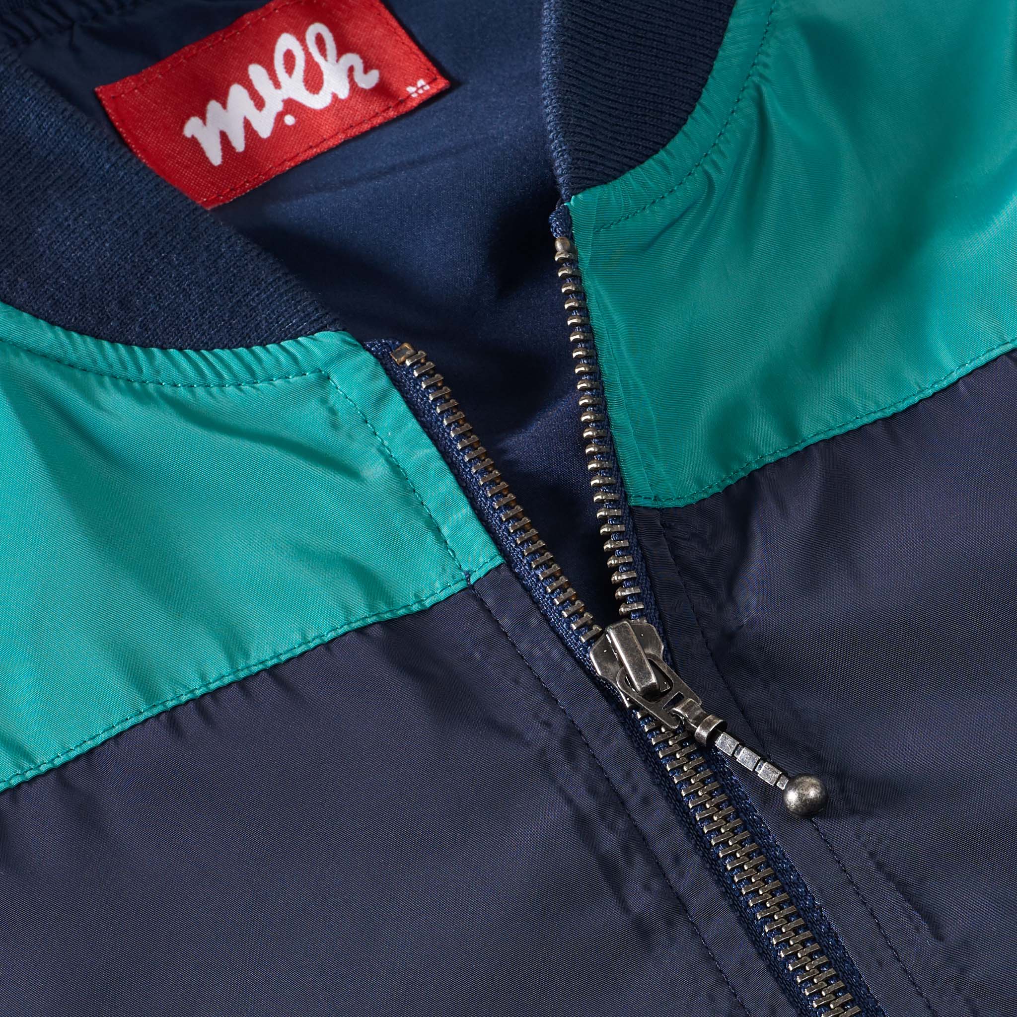 navy and green bomber jacket with zips