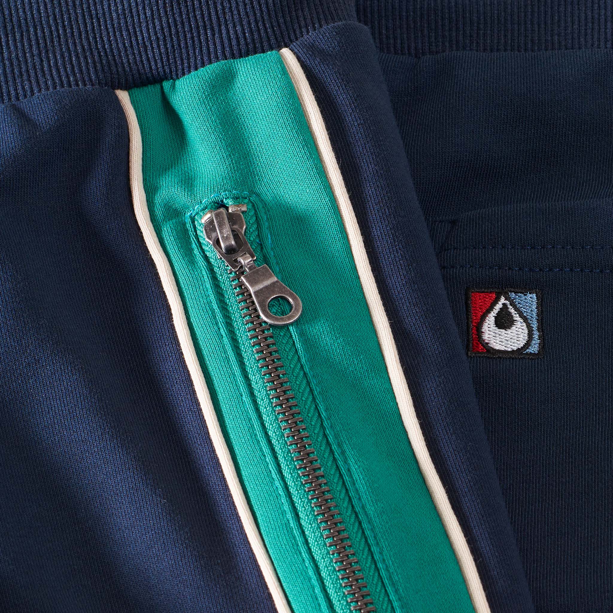 navy and green shorts with zips