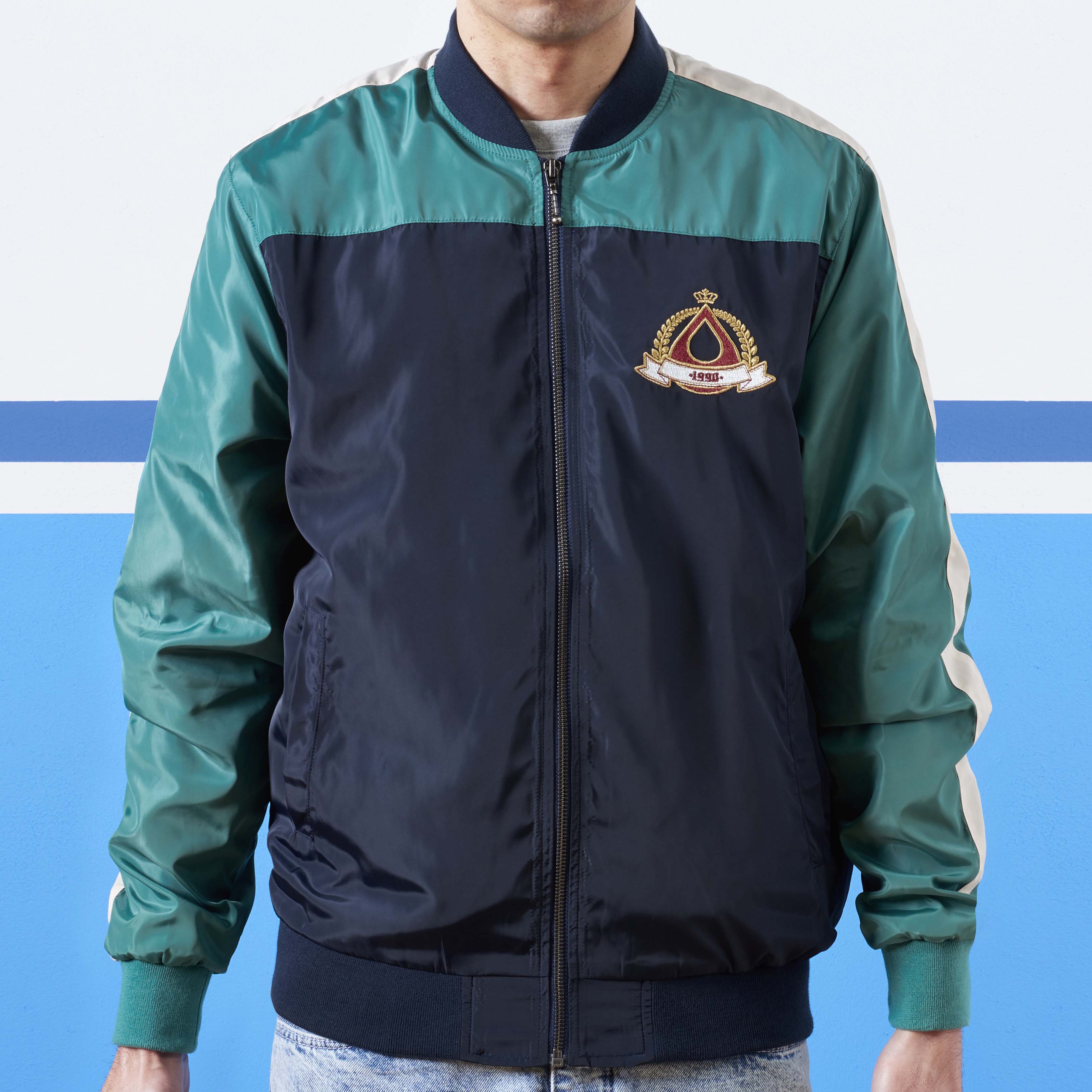 navy and green track jacket with crest embroidery